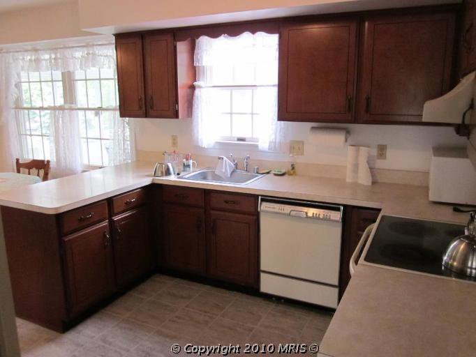 Kitchen Remodel. See how this 1980's kitchen gets some traditional farmhouse kitchen style in this kitchen remodel. See how paint transforms the kitchen cabiets and takes this kitchen from 80's oak to amazing.