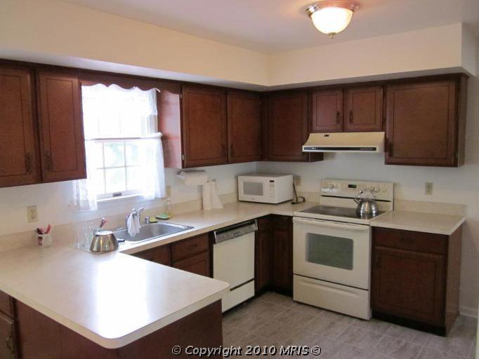 Kitchen Remodel. See how this 1980's kitchen gets some traditional farmhouse kitchen style in this kitchen remodel. See how paint transforms the kitchen cabinets and takes this kitchen from 80's oak to amazing.