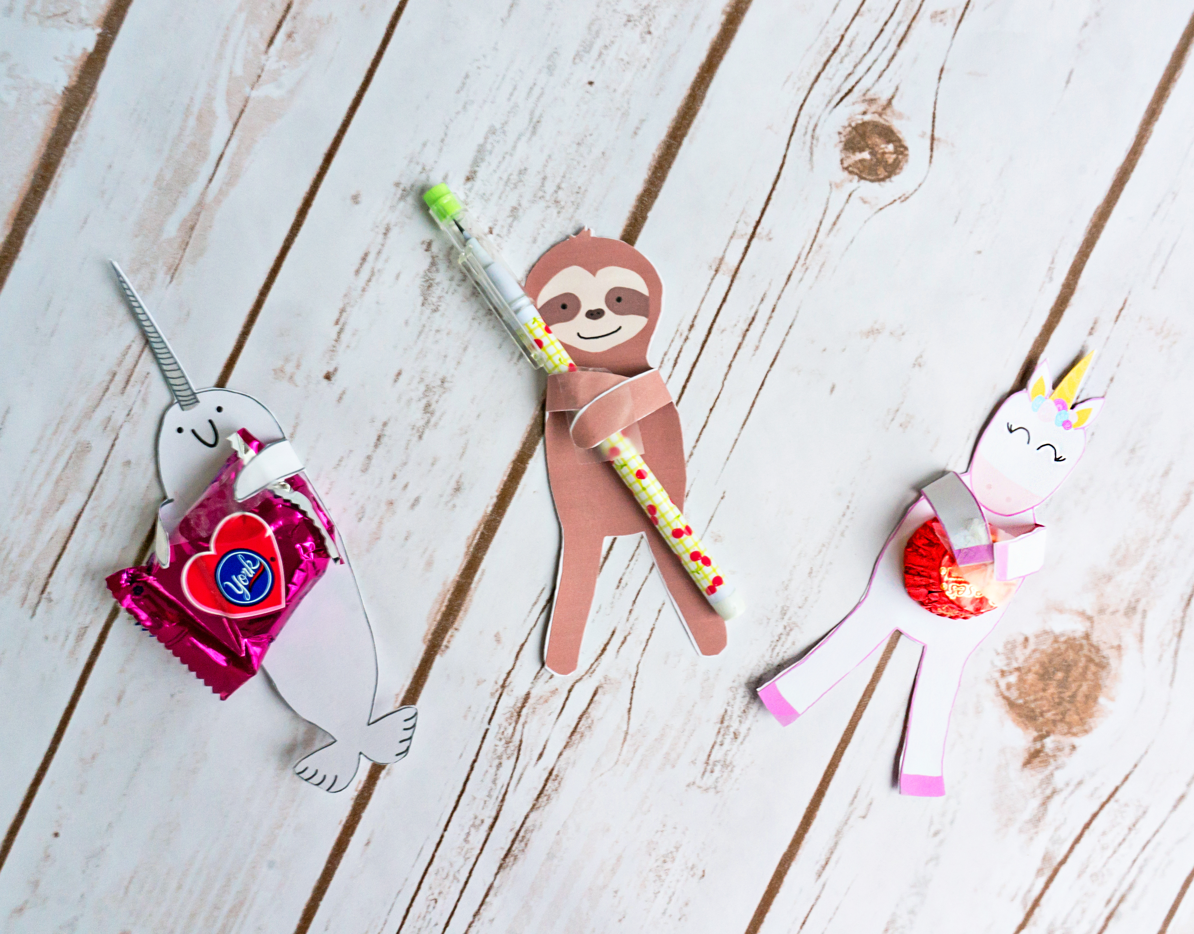 FREE Animal Valentines - Sloth Valentine, Unicorn Valentine, and Narwhal Valentine. Print 3 free valentine candy holders or valentine pencil holders. They can hold any small trinket. #freevalentines #freeprintablevalentines #valentinesday #freeprintables #kidprintables