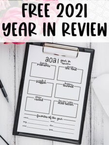 This image represents the free printable that you can download in this blog post. At the top, the image says Free 2021 Year in Review. Below that is the free 2021 year in review printable on a clipboard.