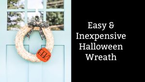 Picture of a wreath on the left side and the words easy and inexpensive Halloween wreath on the right. The wreath is on a blue front door, it's made of straw, has a black and white bow at the top, and a bright orange cutout pumpkin with black letters saying, EEK!