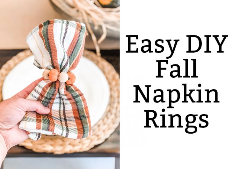 The image is of DIY Thanksgiving napkin rings. They're plaid green, orange, and white napkins with mini pumpkins and wood beads around the napkins. On the right side, the black text on white background says, Easy DIY Fall Napkin Rings.