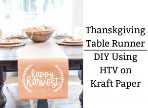 The image shows a kraft paper table runner on a dining table underneath. The words happy harvest are in white on the runner in cursive. There is a small partial wreath on each side of the phrase, happy harvest. On the right side, the phrase in black text says: Thanksgiving Table Runner : DIY Using HTV on Kraft paper.