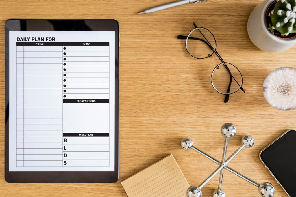 This image shows the free daily planner printable that you can download at the end of this blog post. There are two free daily planner options. This photo shows one of the two, it shows the one with a note section. This shows how the daily planner can be used as on a tablet as a digital planner file as well.