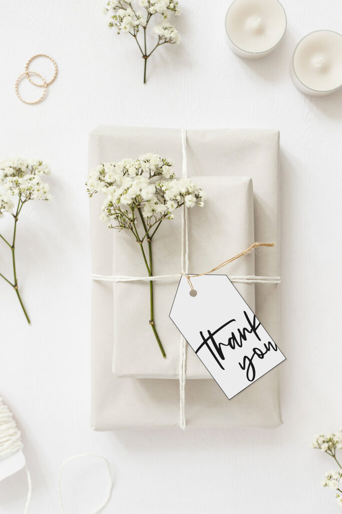 This image is showing one of the two free printable thank you tags that you can download at the end of this blog post. This image shows how the tags can be printed and added to a gift. This shows the black text version of the file.