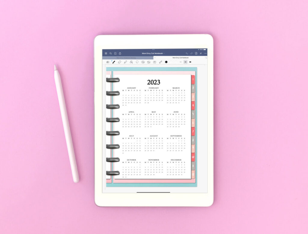 This image shows how you can use the free files you download in this blog post on a table in a digital planner. It's an image of a tablet showing one of the three available 2023 calendars at a glance files.