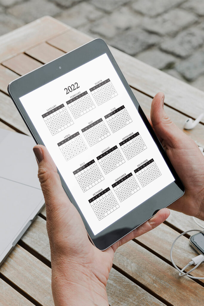 This image shows how you can use the free files you download in this blog post on a table in a digital planner. It's an image of a tablet showing one of the three available 2022 calendars at a glance files.