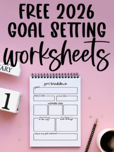 Graphic with the text &ldquo;Free 2026 Goal Setting Worksheets&rdquo; above a spiral notebook displaying a detailed goal breakdown page on a pink background with a pencil, coffee cup, and decorative number blocks.