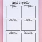 2027 goals worksheet in a spiral notebook on a pink background, showing blank boxes for personal goals, professional goals, new things to try, people to see, places to visit, and ways to help others.