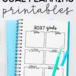 At the top it says free 2027 goal planning printables. Below that it shows an example of the 2027 goal planning sheet in a planner with two pens on top.