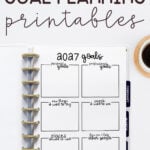 At the top it says free 2027 goal planning printables. Below that it shows an example of the 2027 goal planning sheet in a planner with a cup of coffee in the upper right hand corner.