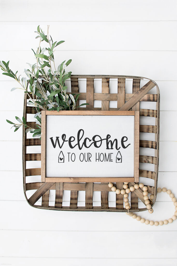 This image shows one of the two versions of the welcome to our home SVG files that are available to download for free at the end of this post. This image shows an example of the free welcome to our home SVG on a sign.