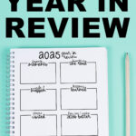 Graphic showing a spiral year-in-review worksheet with bold text reading &ldquo;Free 2025 Year in Review&rdquo; above it, displayed on a mint green background with a pencil on the right.