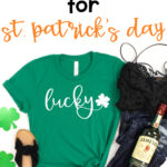 This shirt shows one of the free lucky svg that can be downloaded at the end of this blog post. It has a green shirt with the word lucky in white cursive with a small shamrock. There are also a pair of sandals, jeans, a black tank top, two glittery paper shamrocks, and a bottle of Jameson. Above that is the text Free SVG for St. Patrick's Day.