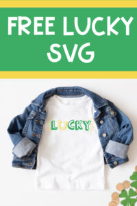 This image shows one of the free lucky SVG files you can download at the end of this blog post. This version is the print lucky with a horseshoe replacing the letter u. The horseshoe is yellow and facing up like a U. The text for the rest of lucky is in green. In this image, it is on a white shirt with a jean jacket over top. In the bottom right corner are some gold coins and some glittery paper shamrocks. Above the shirt is the text, Free Lucky SVG in white on a green background.