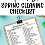 This image is showing the spring cleaning checklist you can download for free at the end of this post. At the top, it says free printable spring cleaning checklist. Below that is a copy of one of the spring cleaning check list pages you can download for free at the end of this post. It is on a clipboard and surrounded by cleaning supplies.
