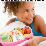 This image shows a little girl holding an open lunch box with one of the free spring lunch notes available to download at the end of this post. At the top, the text: free spring lunch notes is overlayed. At the bottom, the text featuring spring jokes, is overlayed.