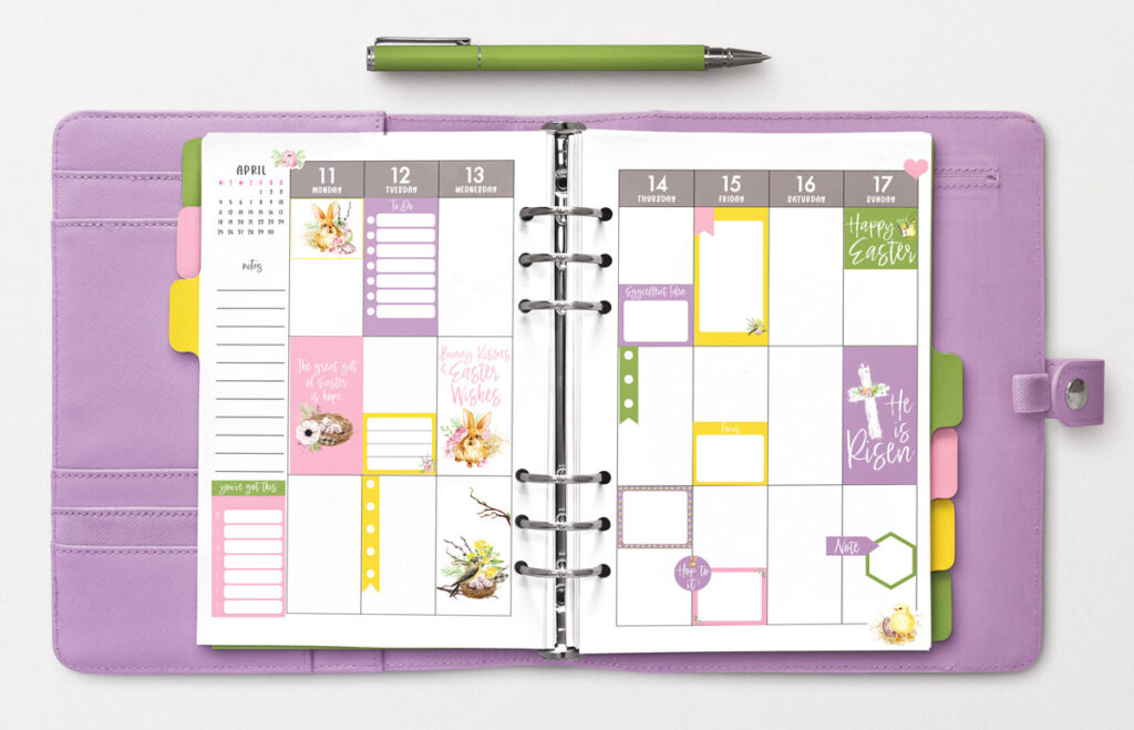 This image shows an example of an open planner with the free Easter planner stickers available to download at the end of this post. The image shows a purple planner that is open to an April weekly spread starting on April 11. There are examples of the free planner stickers scattered on the page. Above the planner is a green pen.