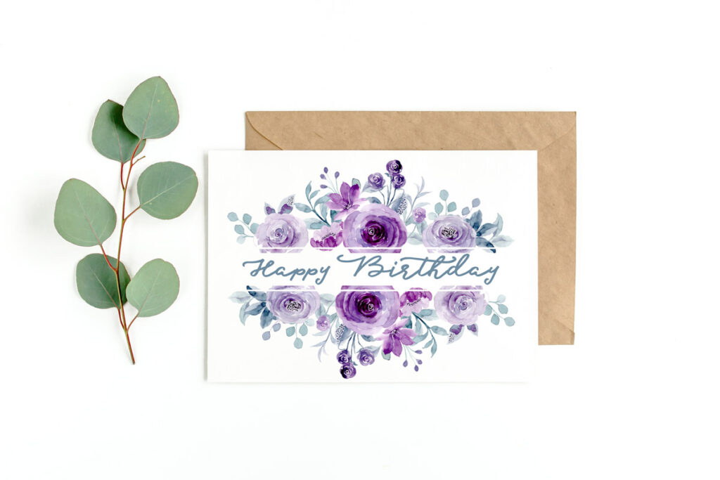This image shows an example of a flower birthday card you can download for free in this set of 8 free printable birthday cards. This image shows a card with flowers in shades of purple at the top and bottom of a white rectangle with a blue-green Happy Birthday in the middle of the white rectangle. At the left is a sprig of green leaves.