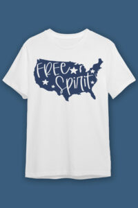 This image shows one of the free 4th of July SVG designs on a white t-shirt. It is a drawing of the United States of America in solid blue with the words free spirit cut out and stars cut out.