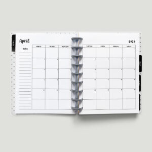 This image is of a planner open to a 2023 calendar with holidays. This is one of the options you can download at the end of this blog post. This image shows a 2023 April calendar with a Monday start.