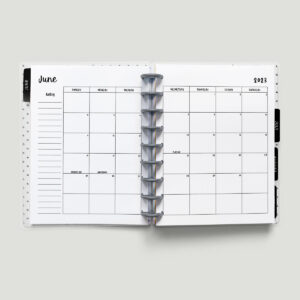 This image is of a planner open to a 2023 calendar with holidays. This is one of the options you can download at the end of this blog post. This image shows a 2023 June calendar with a Sunday start.