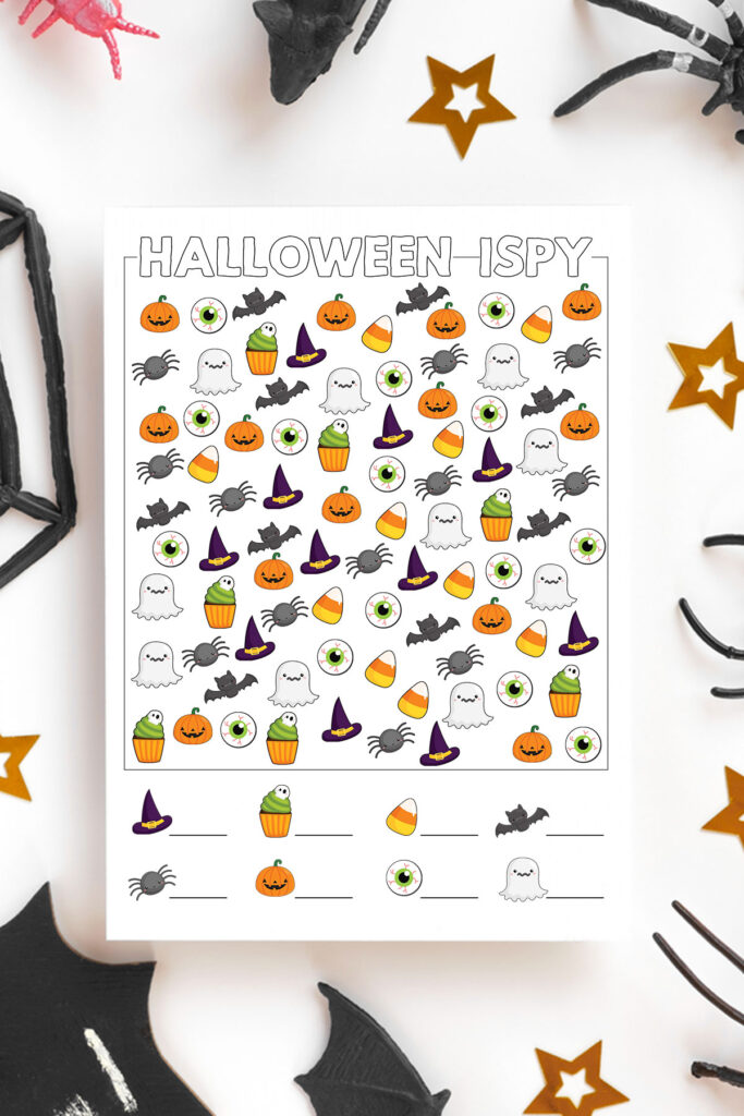 This is an image of one of the free printable Halloween i spy worksheets you can download for free at the end of this blog post. It is surrounded by a few gold stars, part of a black web, and some fake spider legs.