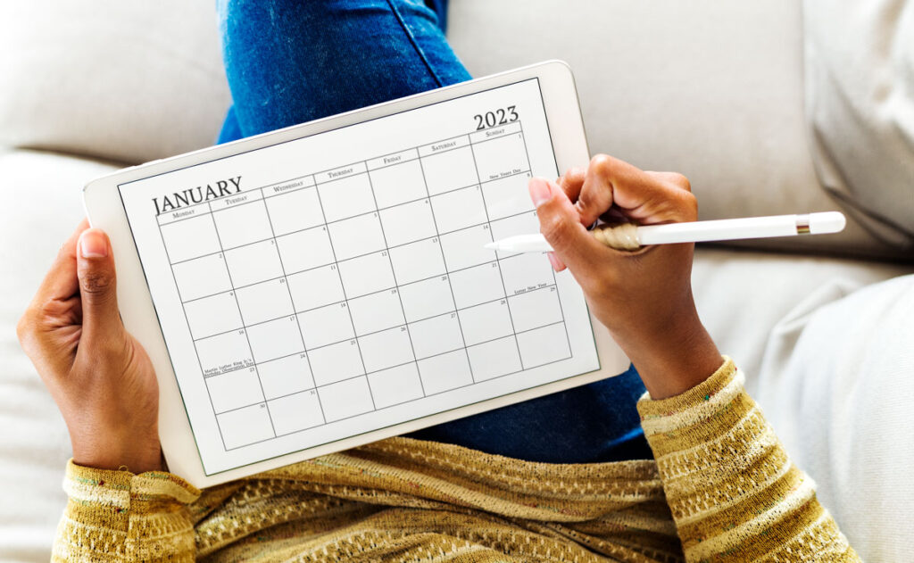 This image shows a 2023 printable calendar one page design on a white table. This is an example of a portion of the 2023 yearly calendar you can get for free at the end of this post. This is showing the month of January 2023 in a simple black text with holidays.