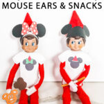At the top, the image says free printable Elf on the Shelf Mouse Ears and Snacks. Below that is an image that shows two Elf on the Shelf dolls wearing their free Elf on the Shelf Mouse Ears and Snacks printable items that you can get for free at the end of this blog post.