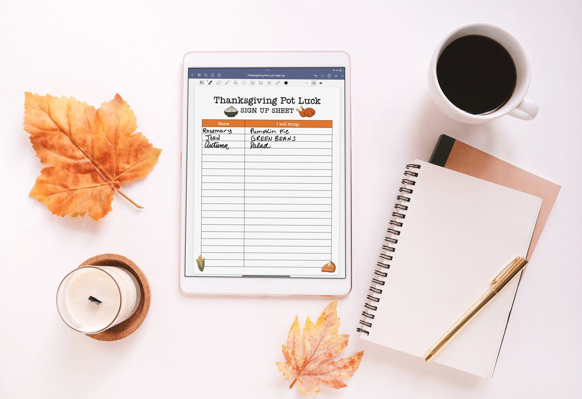 This image is showing an example of one of the available sign up sheets included in the free printable and digital Thanksgiving potluck sign up sheets. This is an example of one of the digital options - it shows an iPad with a Thanksgiving Pot Luck SIGN UP SHEET on the iPad. Next to the iPad is a cup of coffee, candle, 2 leaves, and a couple of notebooks.