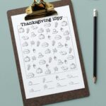 This image shows one of the free I Spy Thanksgiving printables you can grab for free at the end of this post. The image has a small orange pumpkin in the upper right hand corner. Below that is a clipboard with the black and white, easier Thanksgiving iSpy worksheet.