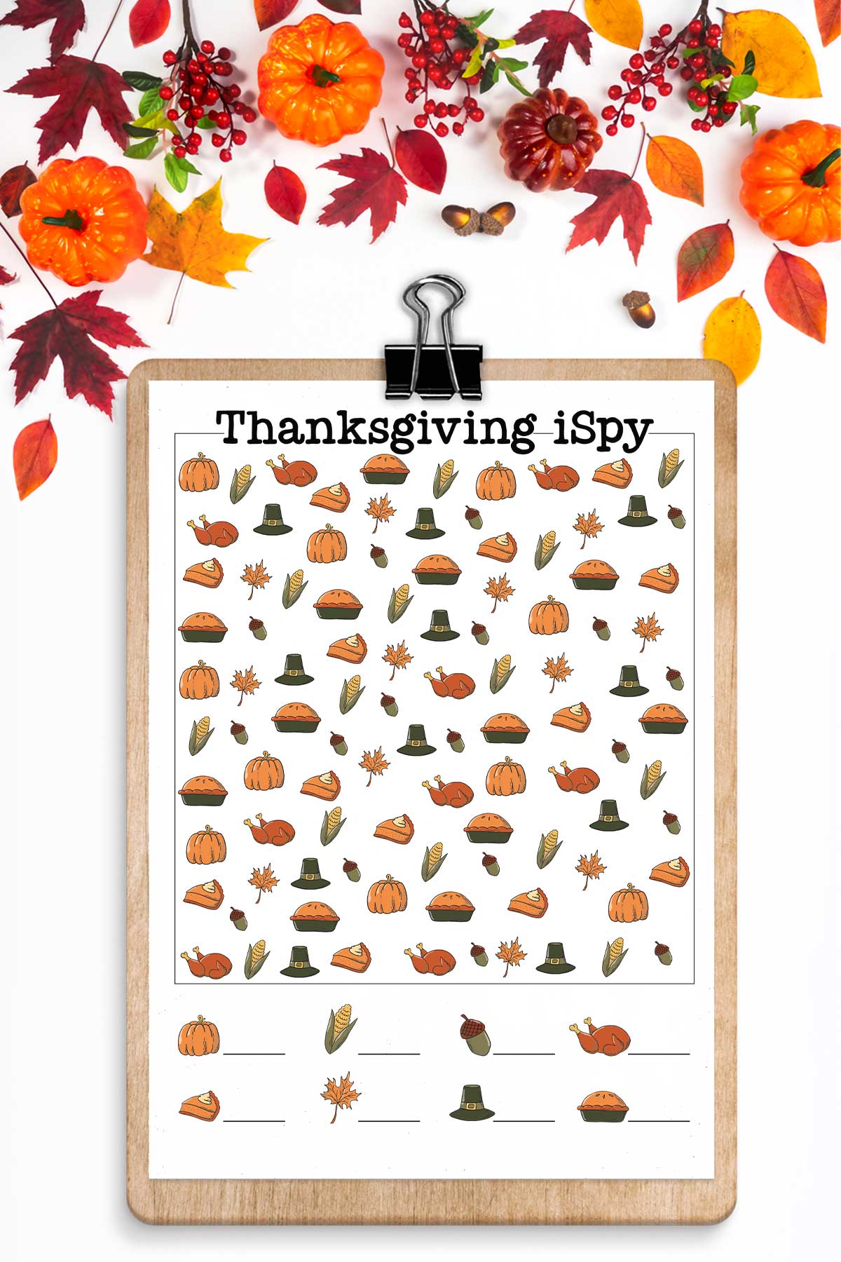 This image shows one of the free I Spy Thanksgiving printables you can grab for free at the end of this post. At the top, the image has leaves and pumpkins. Below that is a clipboard with the colorful, harder Thanksgiving iSpy worksheet.