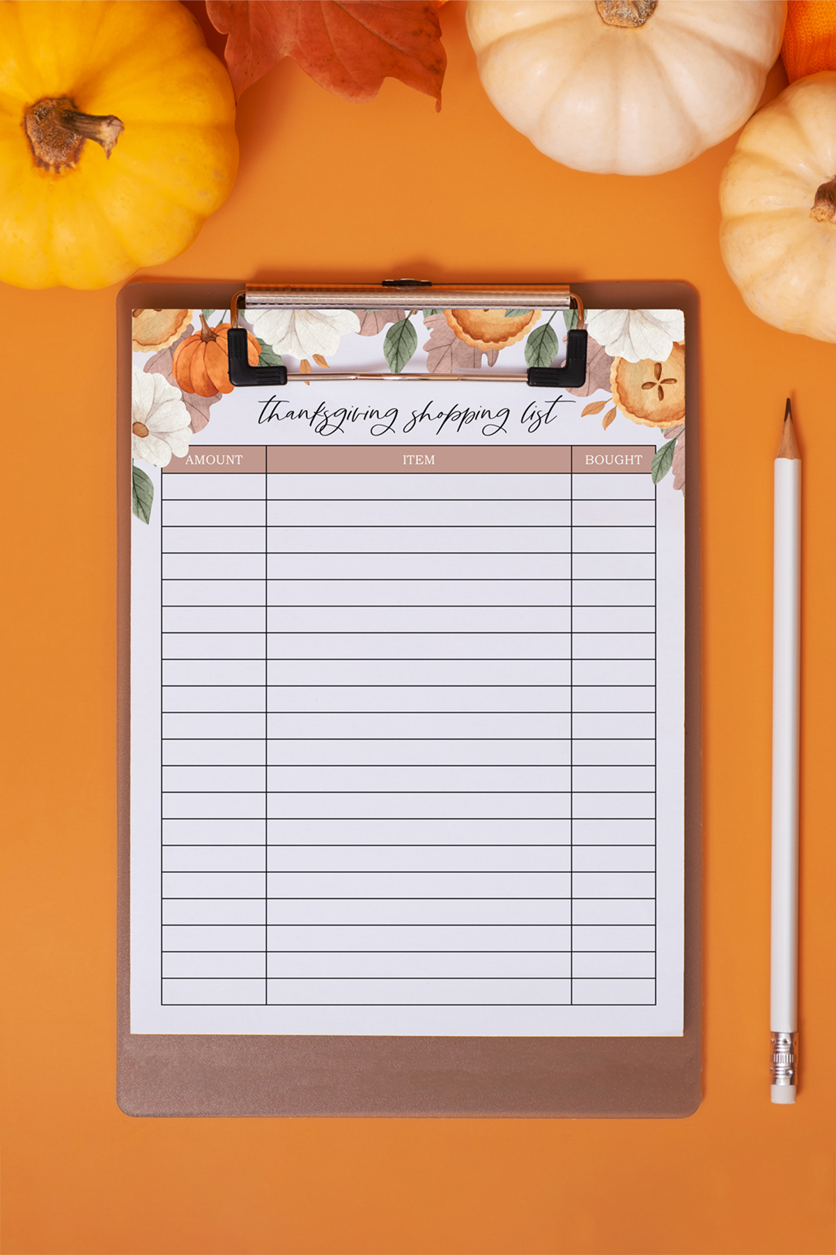 This image shows the free Thanksgiving shopping list printable you can get as part of the Thanksgiving shopping list printable, to do lists, and menu planner set at the end of this blog post. This image shows the shopping list on a clip board surrounded by some pumpkins and a pencil.