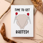 This image shows one of the printable thanksgiving cards you can get for free at the end of this post. This card says time to get basted! With a raw turkey holding 2 turkey basters. The card is surrounded by twigs and leaves.