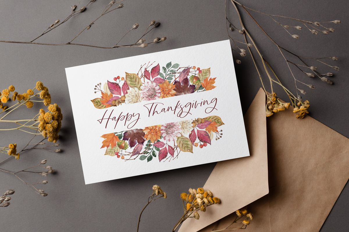 This image shows one of the free Thanksgiving cards you can get from the thanksgiving cards printable set. This card says Happy Thanksgiving and is surrounded with fail florals and foliage. It is surrounded by a few fall flowers.