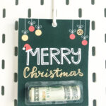 This shows one of the Christmas chapstick money holder card that you can get for free at the end of this blog post. This example is the Merry Christmas money gift card.