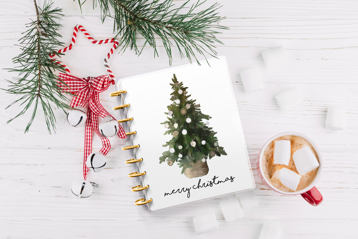 This image shows one of the designs you can get in this free Merry Christmas planner cover and inserts set. It has the picture of a tree with some ornaments on it.