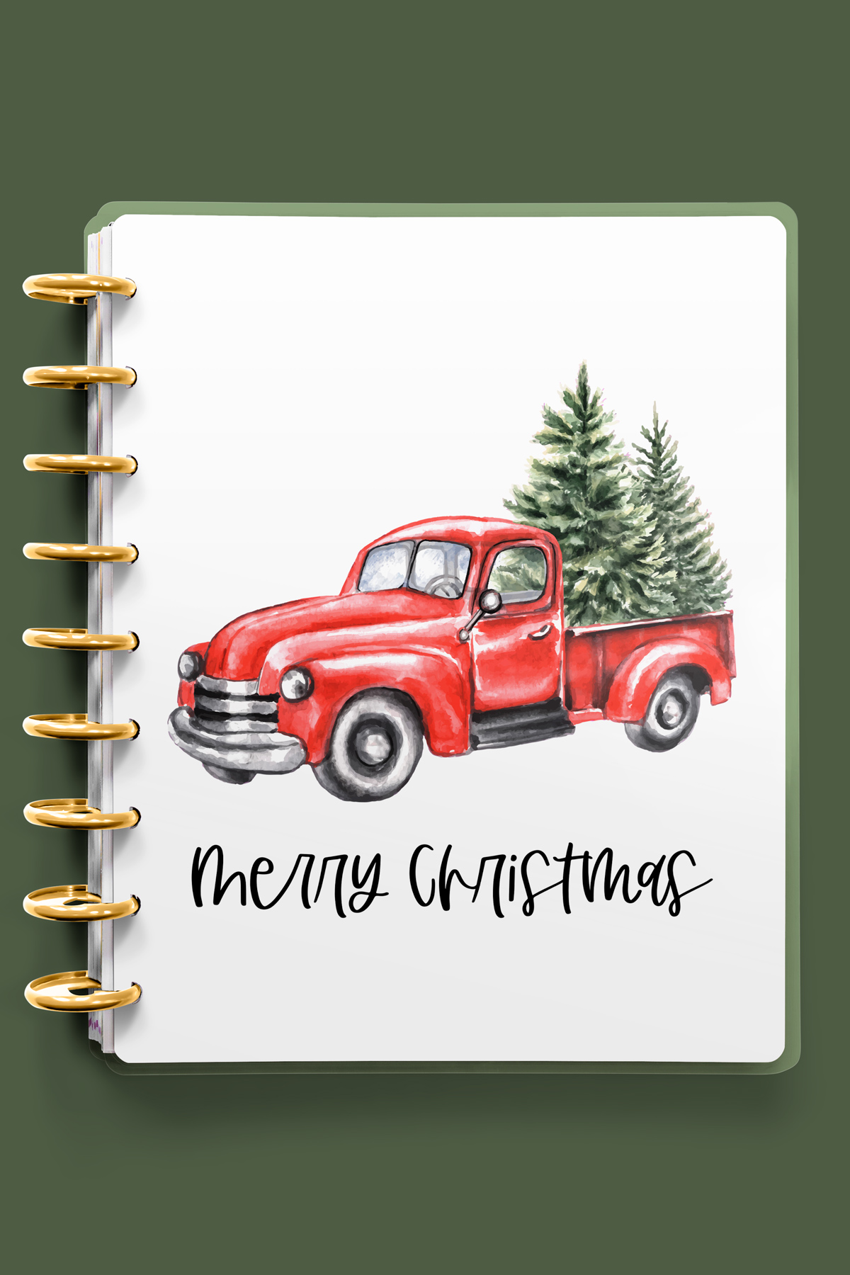 This image shows one of the designs you can get in this free Merry Christmas planner cover and inserts set. It has a red truck with trees in the truck bed.