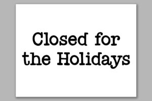 This image shows one of the free printable closed for Christmas sign templates. It says closed for the holidays.