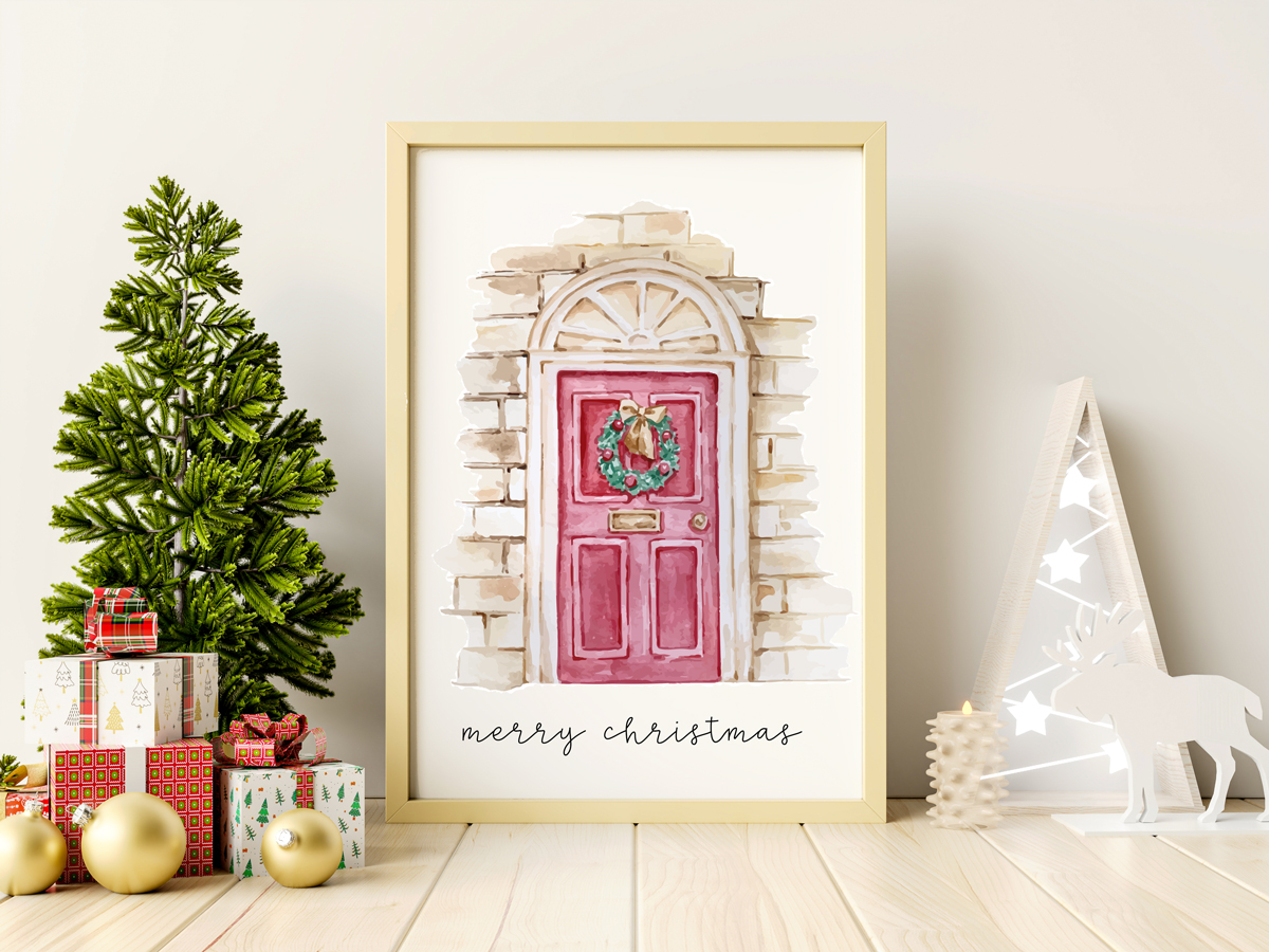 This image shows one of the designs you can get in this free Merry Christmas printable set of cards and prints. It says Merry Christmas on it and has a picture of a front door with a Christmas wreath on it.