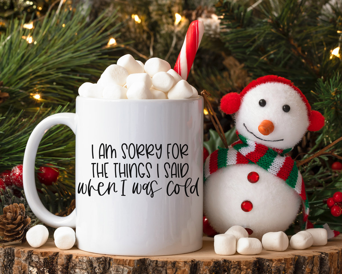 This image shows one of the free winter SVGs you can get at the end of this blog post. The SVG showing is on a mug and says, “I am sorry for the things I said when I was cold.”