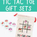 At the top it says Valentine's Day Tic Tac Toe gift sets. At the bottom it says free cut files included. This image is showing the Valentine tic tac toe SVG you can get for free in this blog post. It is being showed on a small brown canvas bag and with small little clear gems that say x and on on them. There is also a name on the front it says Jack. The back shows a tic tac toe board with the words tic tac toe at the bottom.