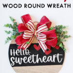 At the top, the image says Valentine's Day wood round wreath. Below that it shows an image of the completed DIY Valentine's Day wreath made out of a wood round.