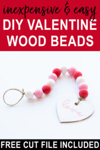 At the top it says inexpensive and easy DIY Valentine wood beads. Below that, the image shows the final DIY Valentine wood beads with a wood heart painted in white that says love in cursive in pink on it. At the bottom, it says free cut file included.