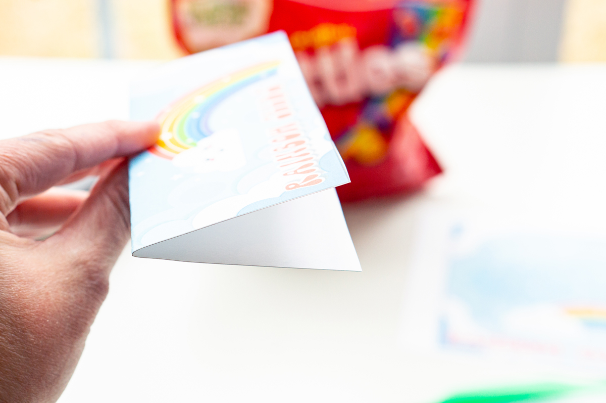 This image is showing the rainbow seeds printable bag topper folded in half longways.