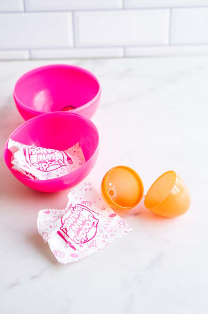 This image shows a plastic easter egg next to a non candy item of mini brands.