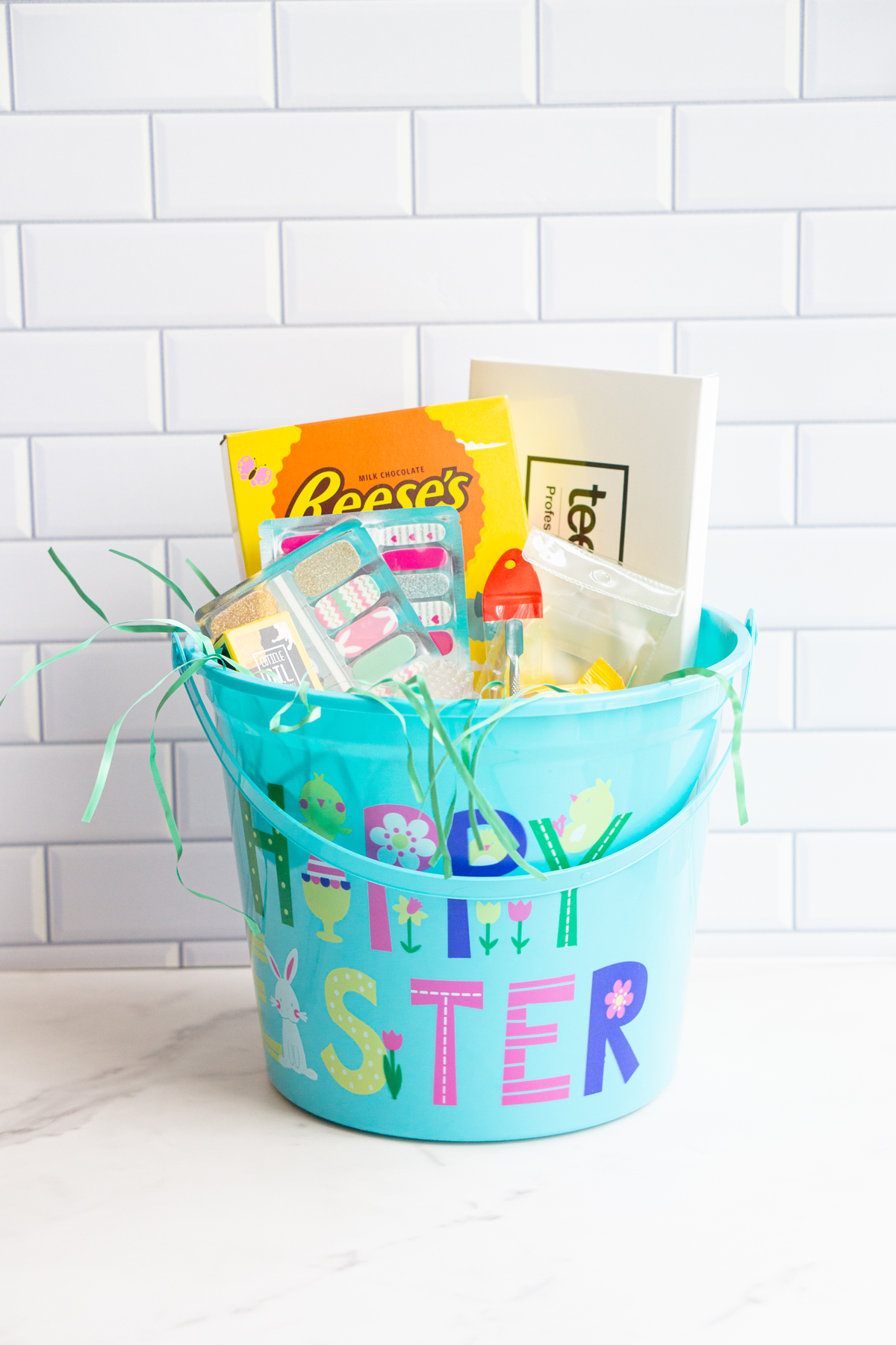 This image is of an adult Easter basket filled with nail products and a Reese's chocolate bunny.