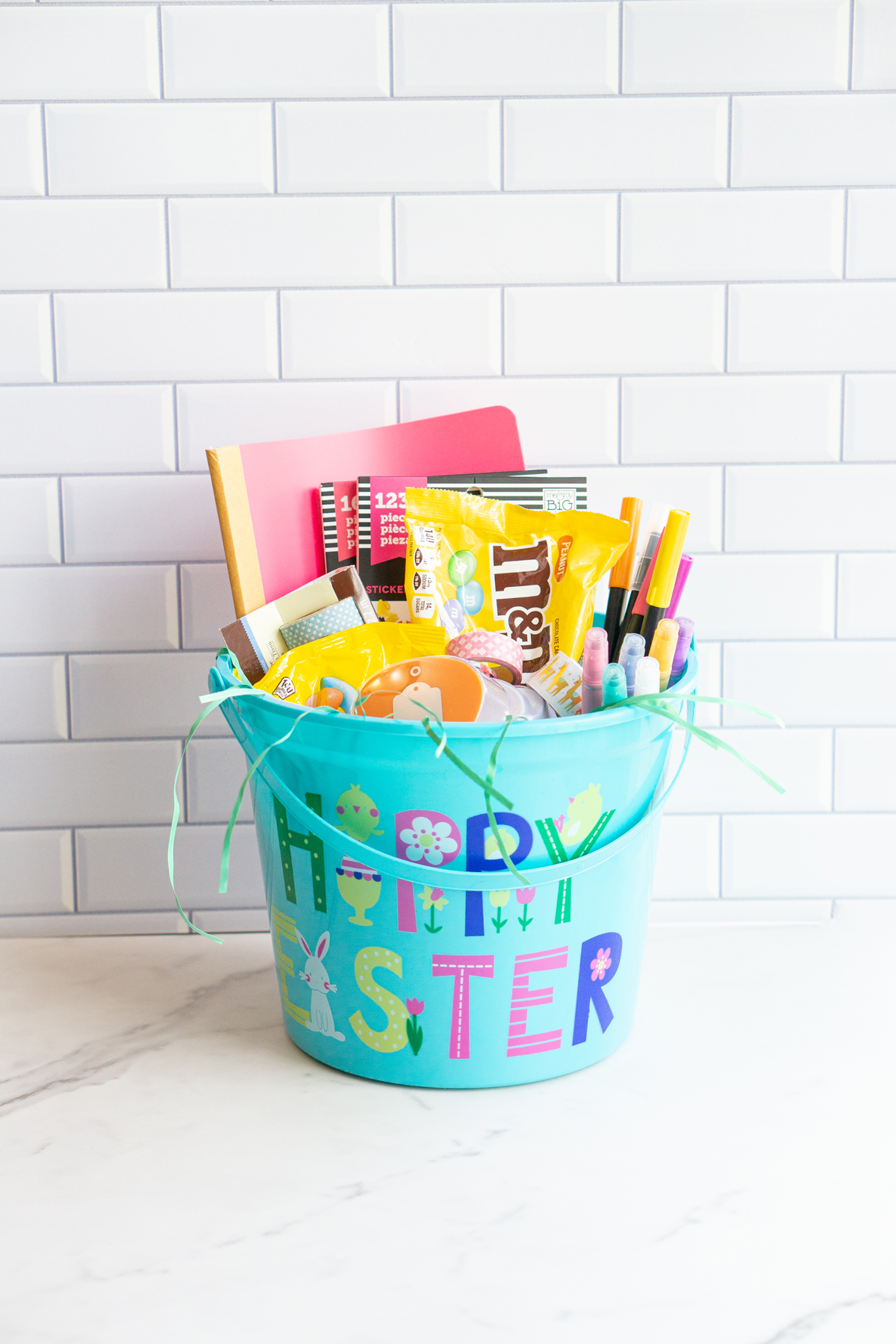 This image is of an adult Easter basket filled with planner and craft supplies and candy.