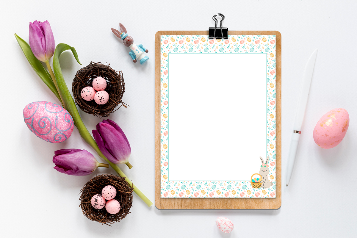 This is an image of one of the free Easter bunny note printables you can download in this post. It shows the note that is blank with a Easter egg border and an Easter bunny drawing in the bottom right corner. The letter is on a clip board and next to a pen, Easter eggs, small eggs in nests, a stem of flowers, and a small bunny figurine.