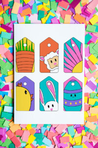 This image shows the 6 free cute printable Easter gift tags you can download at the end of this post. They are in bright, bold colors. There is a carrot, lamb, flower, chick, bunny, and Easter egg. The page of gift tags is surrounded by confetti.